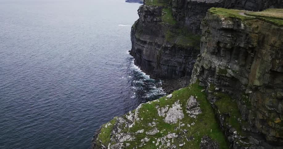A rocky cliff borders the ocean