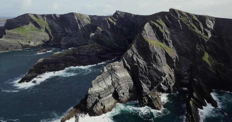 Waves crash against this mountain