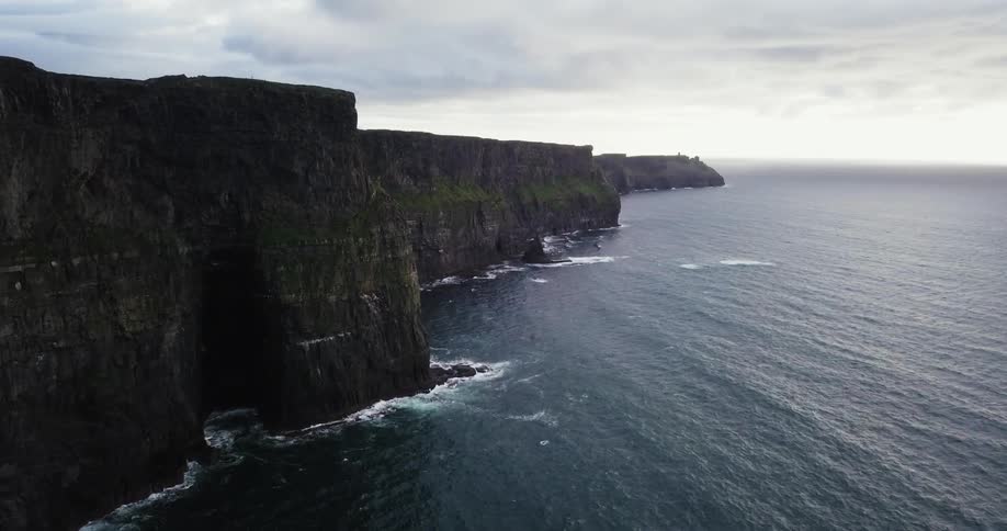 The tall cliffs are lined by the ocean
