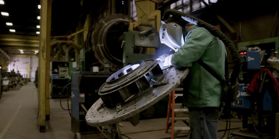 A welder works in a factory