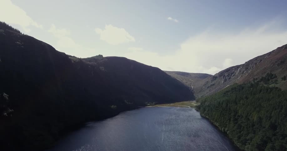 A mountain lake is shown on a sunny day