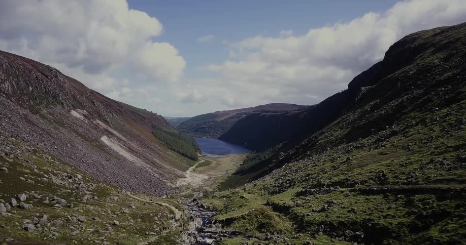 The mountains dip into a small stream of water