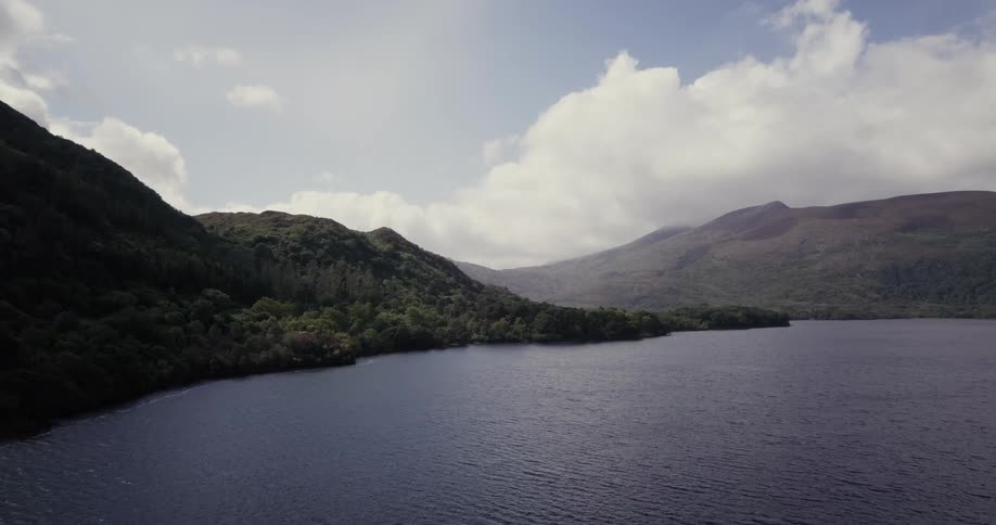 Lush green mountains over a lake on cloudy day