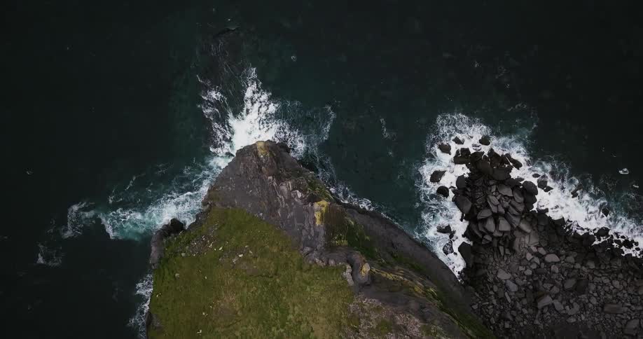 Waves crash against a rocky shore