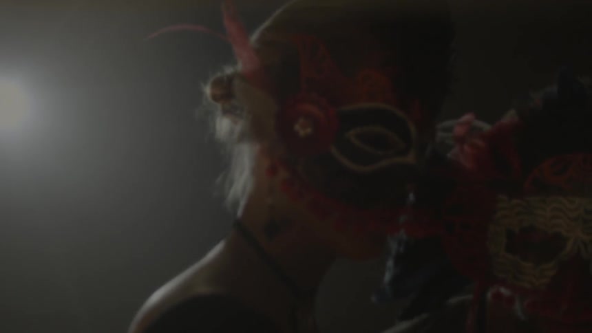 A man and woman dance while wearing face masks