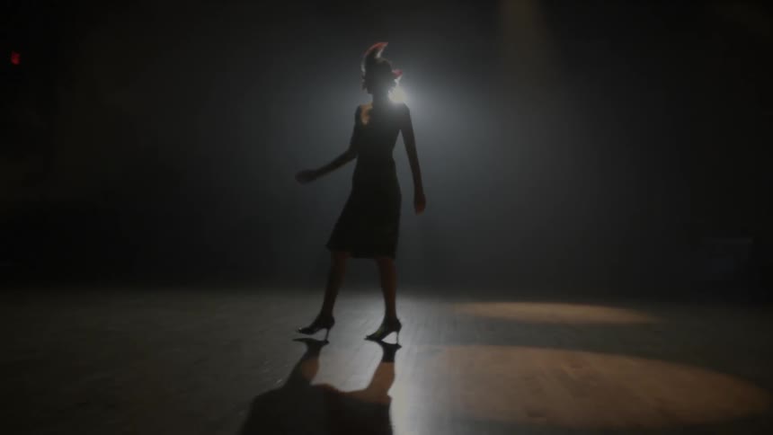 A woman slowly walks turning on the dance floor