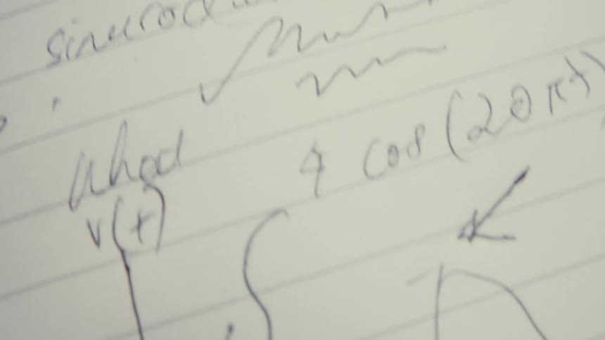 An extreme close-up macro shot of handwritten notes detailing complex mathematical and physics equations