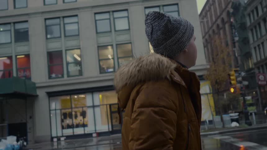 A man is walking down a city street