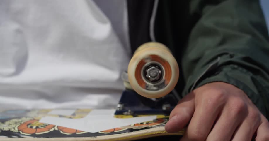Someone spinning a skateboard wheel while it is upside down
