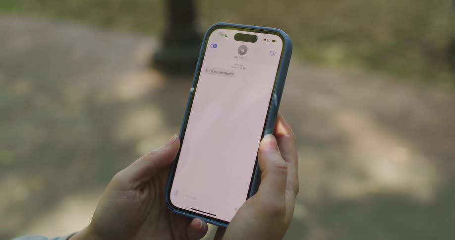 A person drops their smartphone in shock after receiving a text message asking for a rematch
