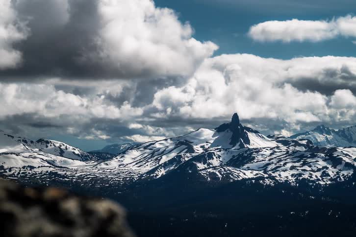A stunning timelapse reveals an iconic mountain peak as dynamic clouds sweep across the vast, snow-covered landscape