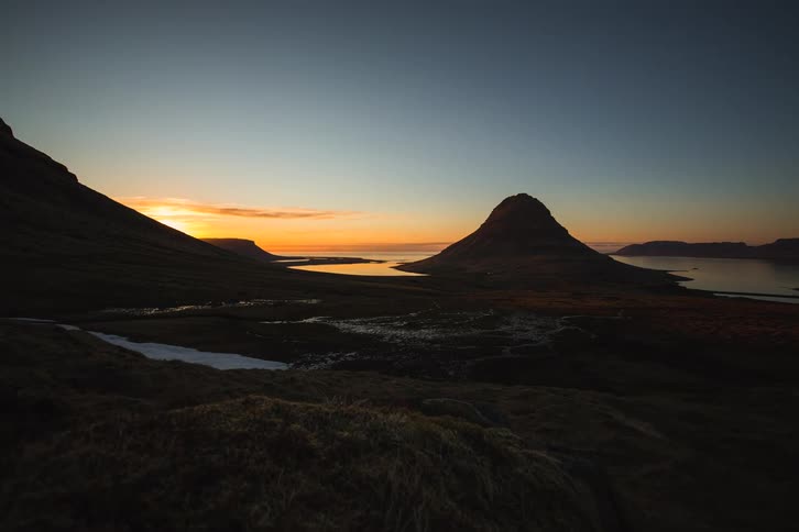 A stunning timelapse captures the last light of sunset fading behind the iconic Kirkjufell mountain in Iceland
