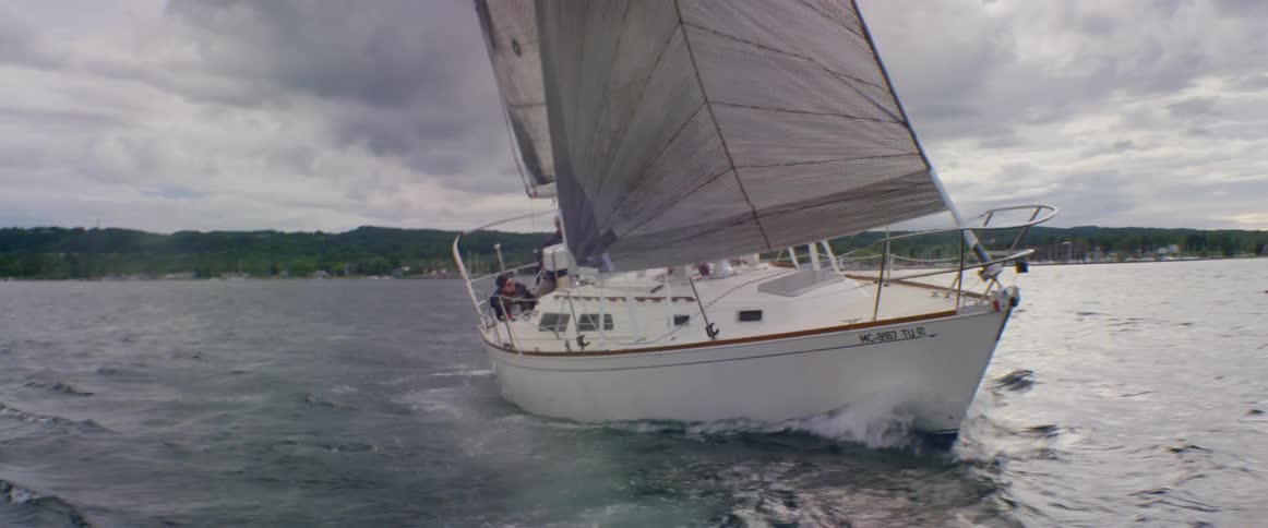 A boat sails full mast