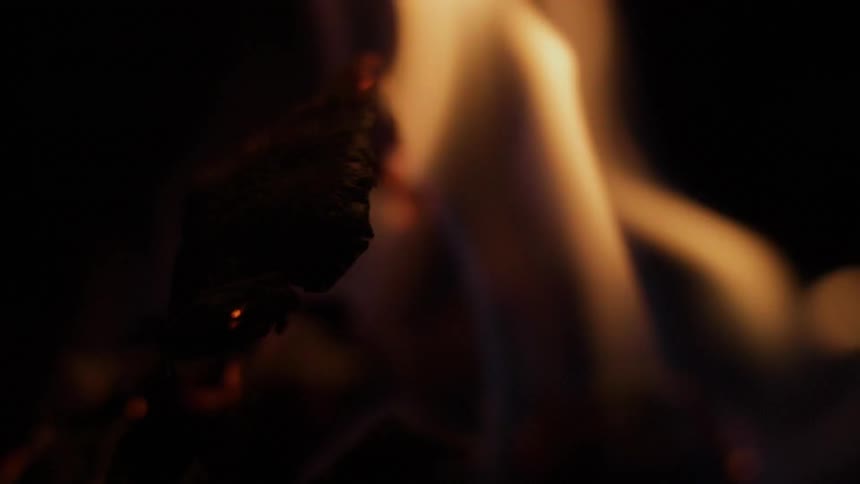 A fire burns causing hot ash to rise