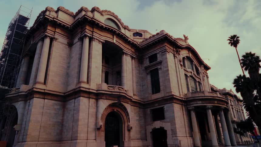 A beautiful timelapse shows morning sunlight moving across the facade of a grand, historic building with classical architecture