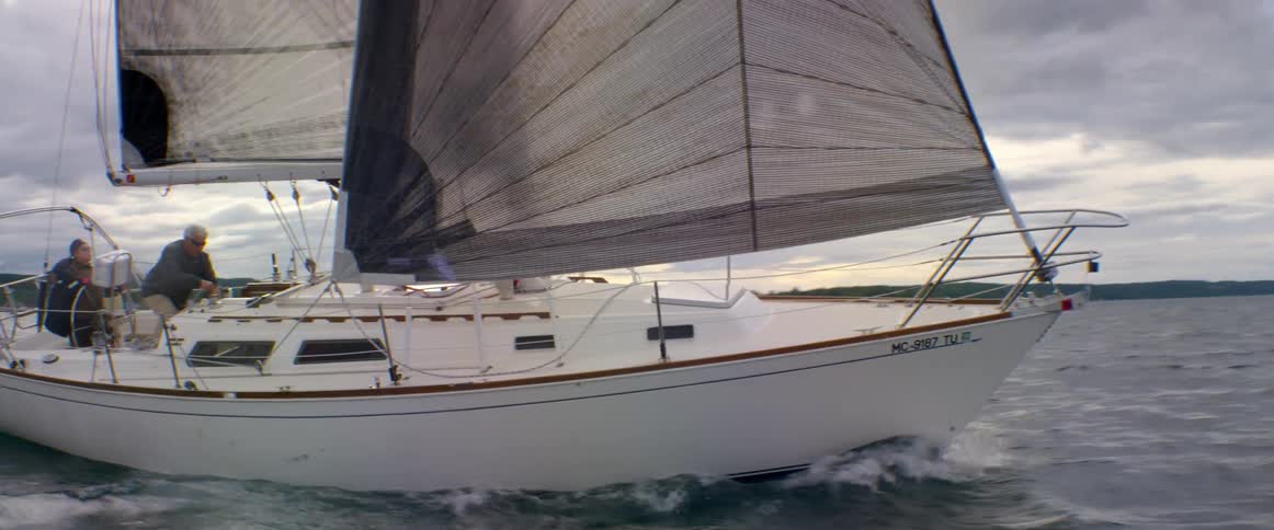 A boat sails fast in the water