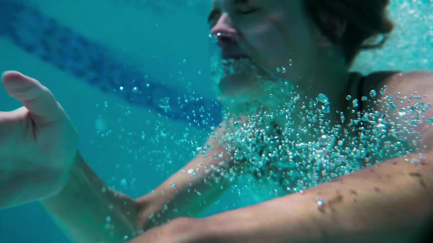 A woman dives into the water