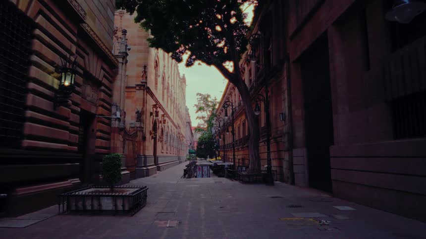 A steady camera push through a quiet and beautiful alley with old European buildings