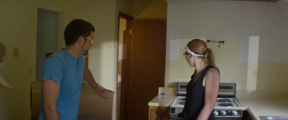 Man and women talk in a kitchen