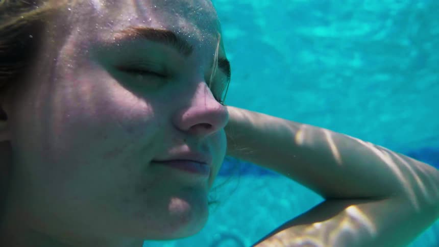 A woman floats right under the surface of the water