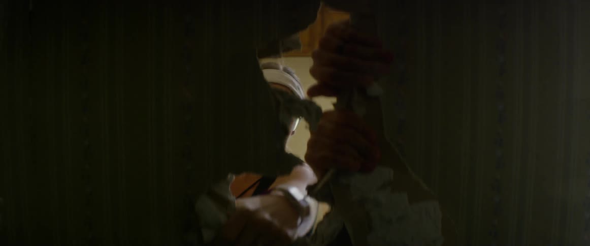 A woman and man demolish a wall
