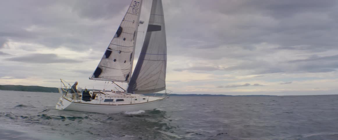 Sailboat on water on a cloudy day