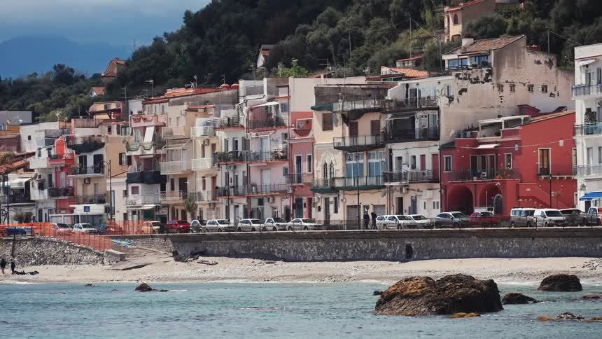 Scenic view of the colorful houses of a coastal town in Italy lining the beach and road by the sea