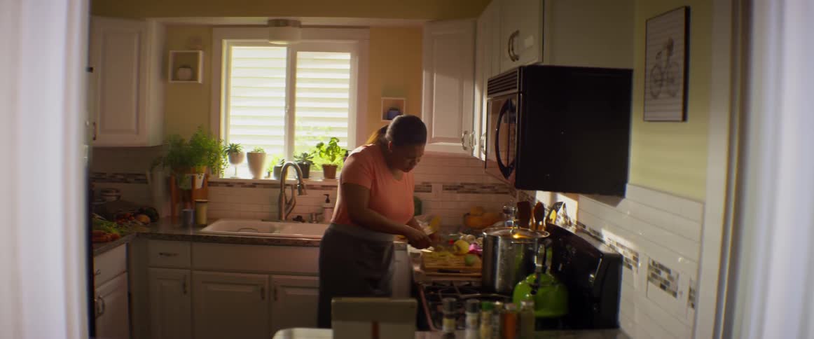 A woman is preparing food in a kitchen