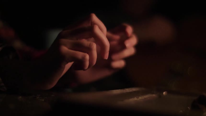 A person puts their hands near a fire