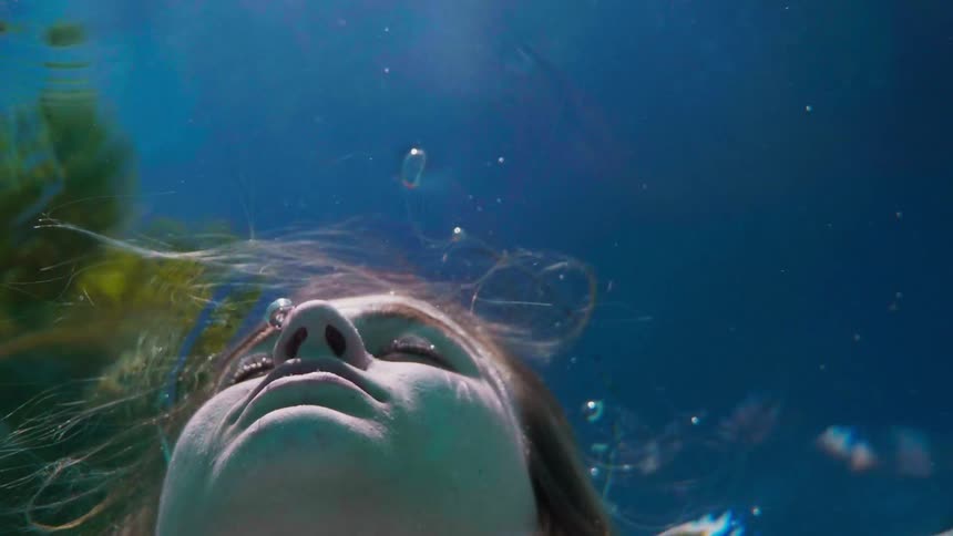 A woman is submerged in water