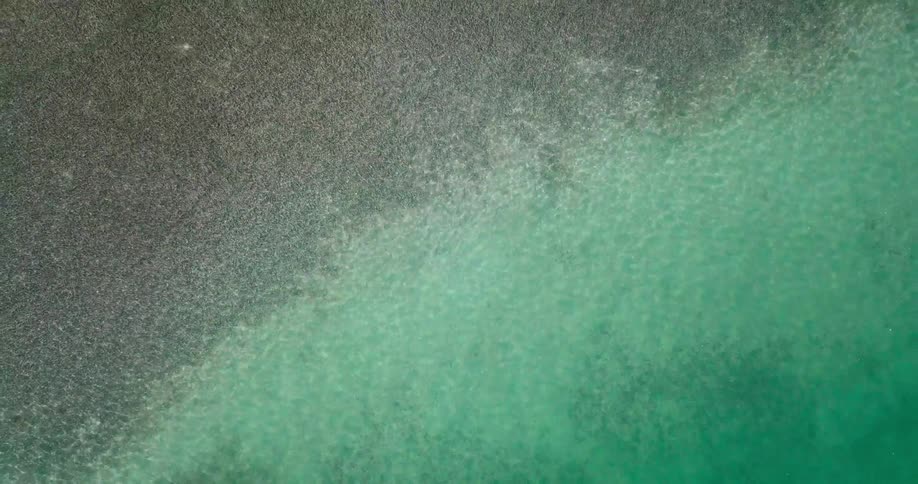 You can see sand and rocks under the clear water