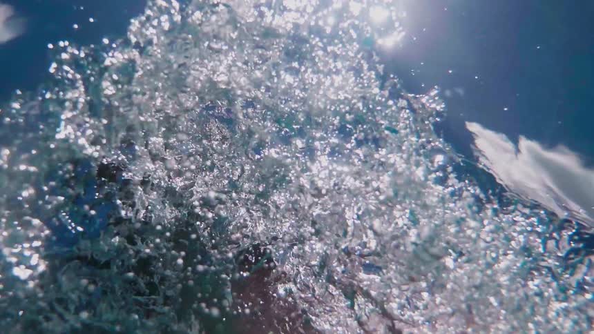 A woman breaks through the surface of water