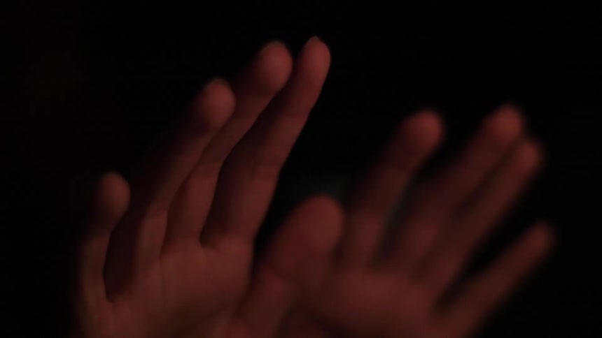 A person is warming their hands by the fire