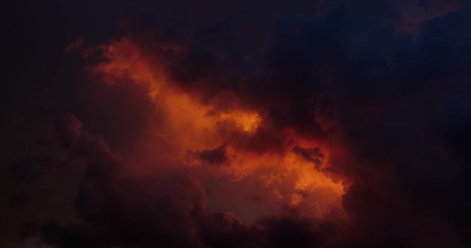 The clouds have red light coming through