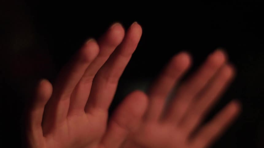 A close of view of someone's hands trying to warm up