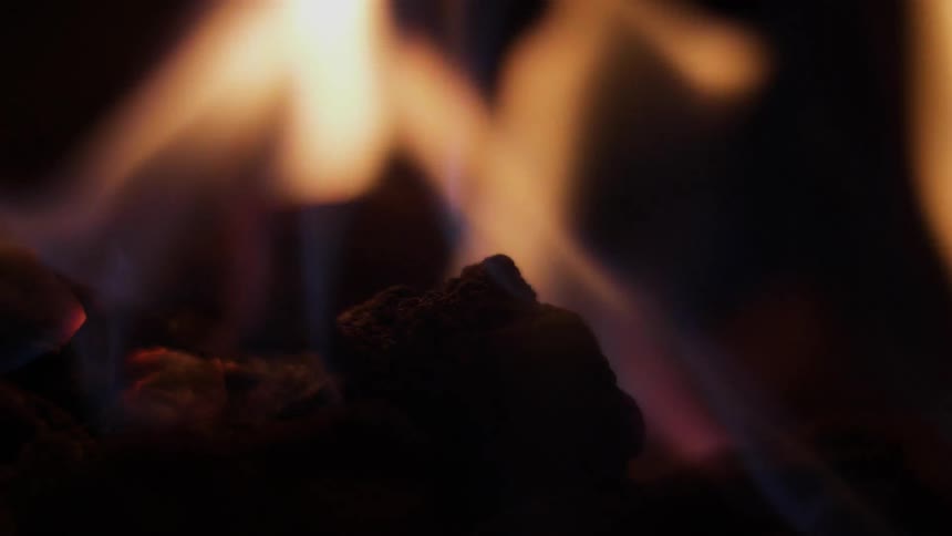 Flames of a fire cause the wood to glow red