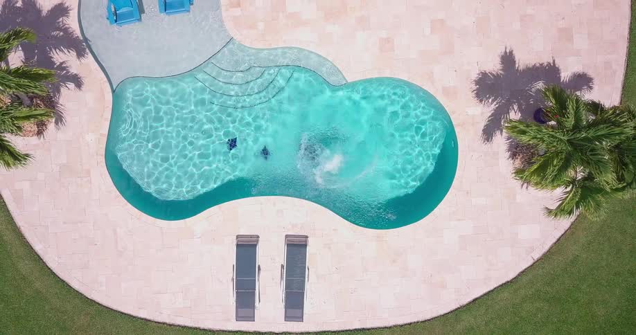 A woman jumps into a swimming pool