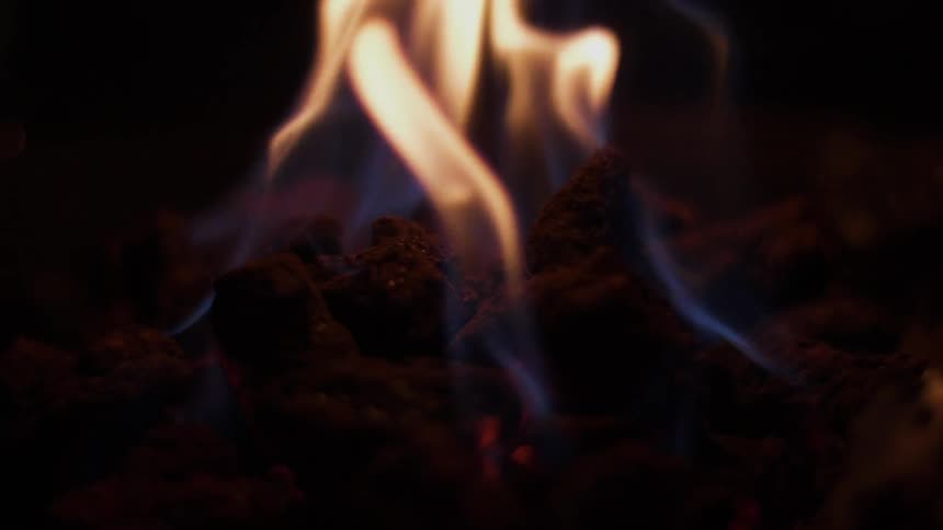 Flames of a fire cause the wood to glow red