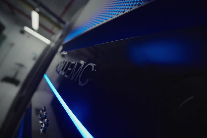 A sleek DELL EMC logo is revealed on a server with a glowing blue LED light in a modern data center
