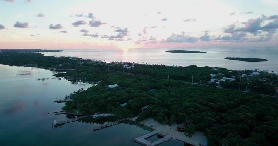 The sun is setting beyond an isthmus