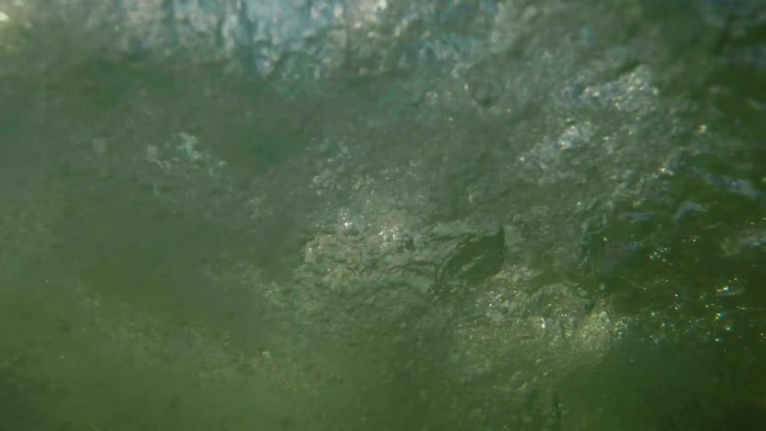 A person kicks their legs in the water