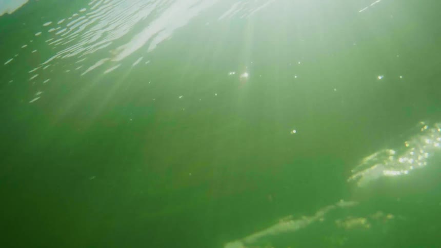 The light shines in under the green water