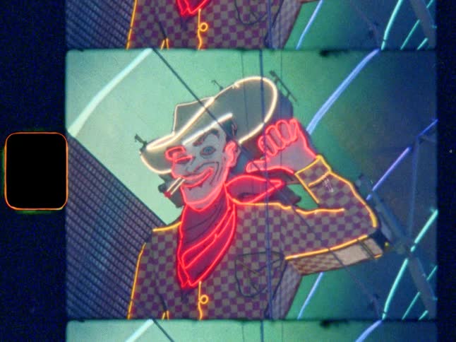 Vintage Vegas smoking cowboy neon sign, on Super 8 film