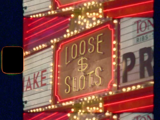 Vegas casino neon sign, “LOOSE SLOTS”, on Super 8 film
