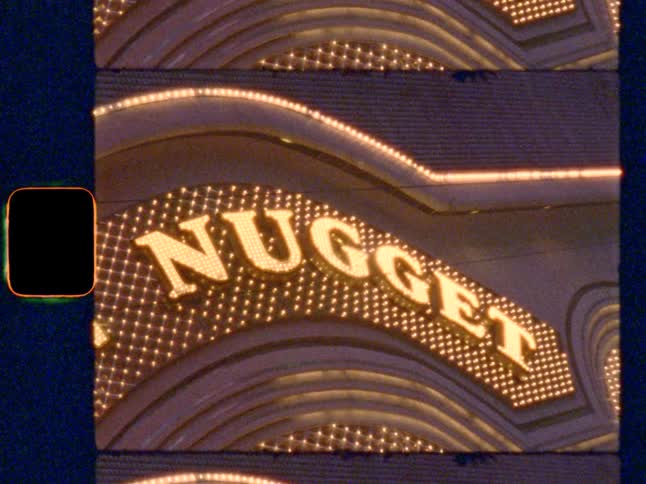 “Nugget" Vegas neon sign with flashing marquee lights at night, on Super 8 film