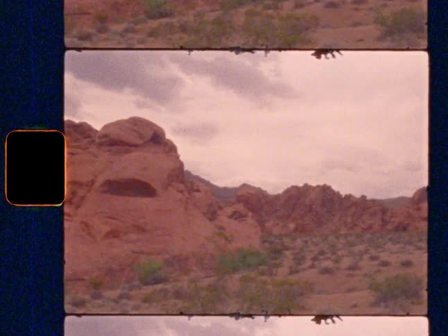 Super 8 film pan across a majestic red rock desert landscape