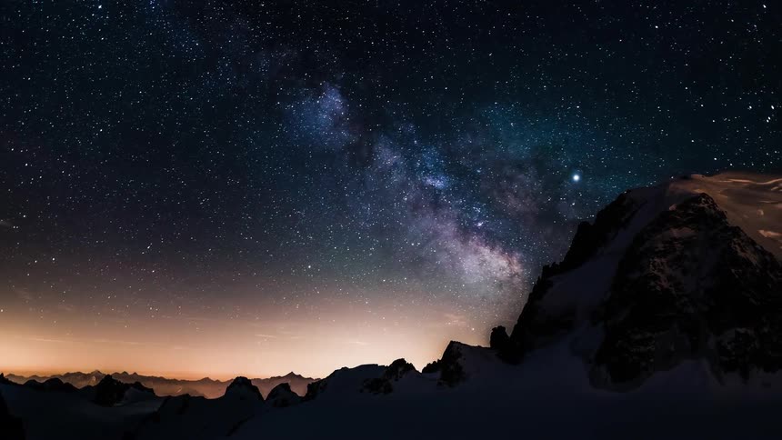 A stunning timelapse captures the Milky Way galaxy moving across a star-filled night sky above a snowy mountain range
