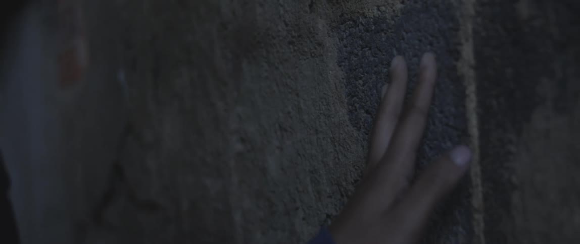 Close up of hand touching a wall