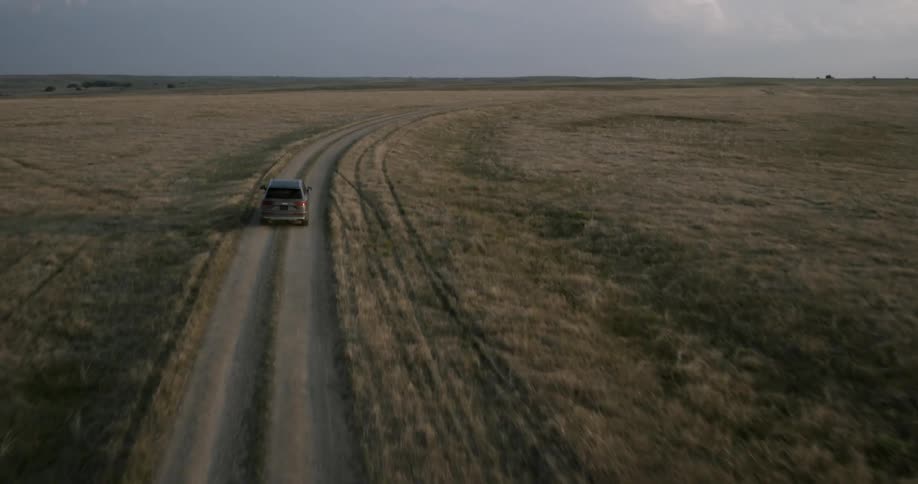 Car traveling on dirt country road