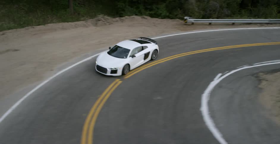 A white car makes a steep turn